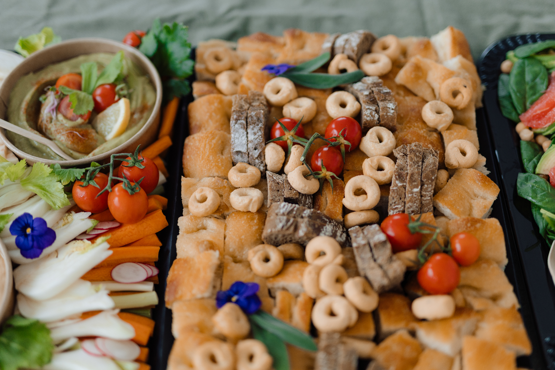 Grazing table of breads, vegetables, and dips