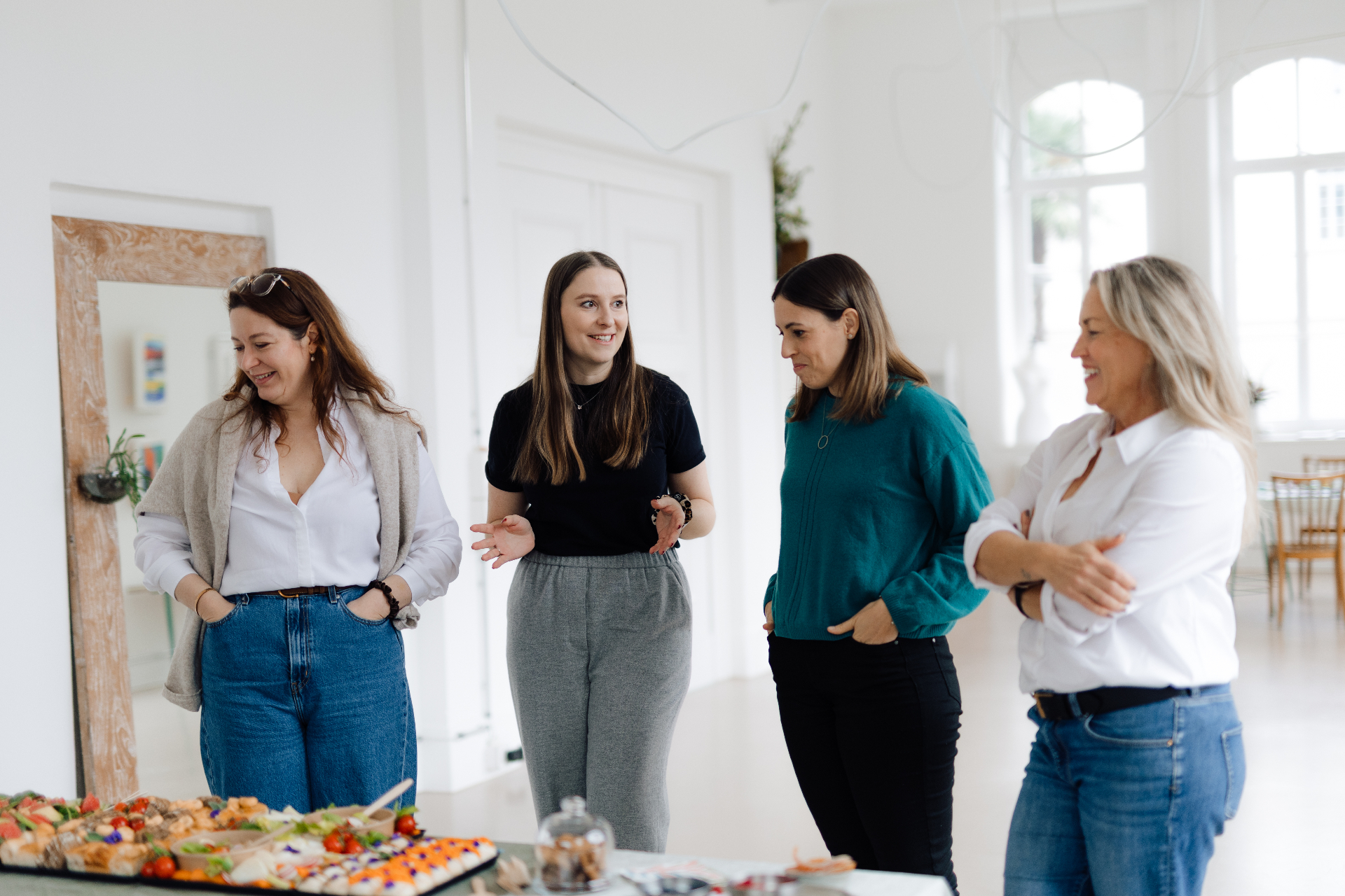Cohort of four women in conversation